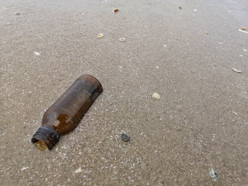 Garbage bottle onâ€‹ theâ€‹ beach royalty free stock image