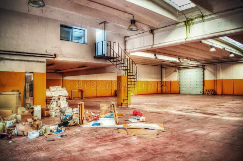 Garbage in an empty warehouse stock image
