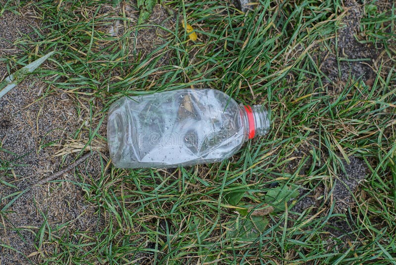 Garbage from one small empty white plastic bottle royalty free stock photography