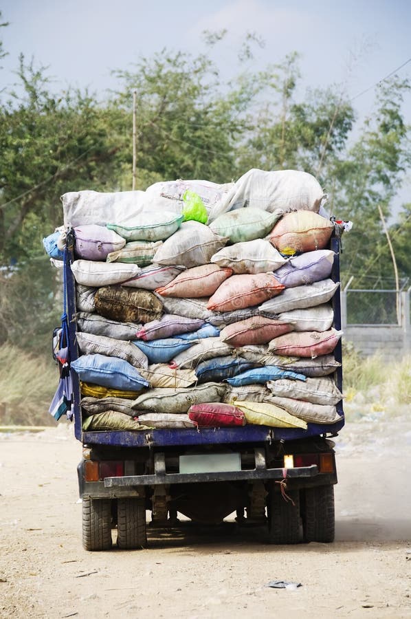 Overloaded with bags of waste, vehicle moves on higway, Shiraz, Iran. –  Stock Editorial Photo © grigvovan #167601202