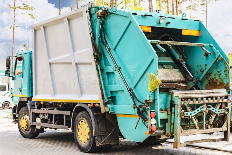 A Garbage Truck Picks Up Garbage in a Residential Area. Loading Mussar