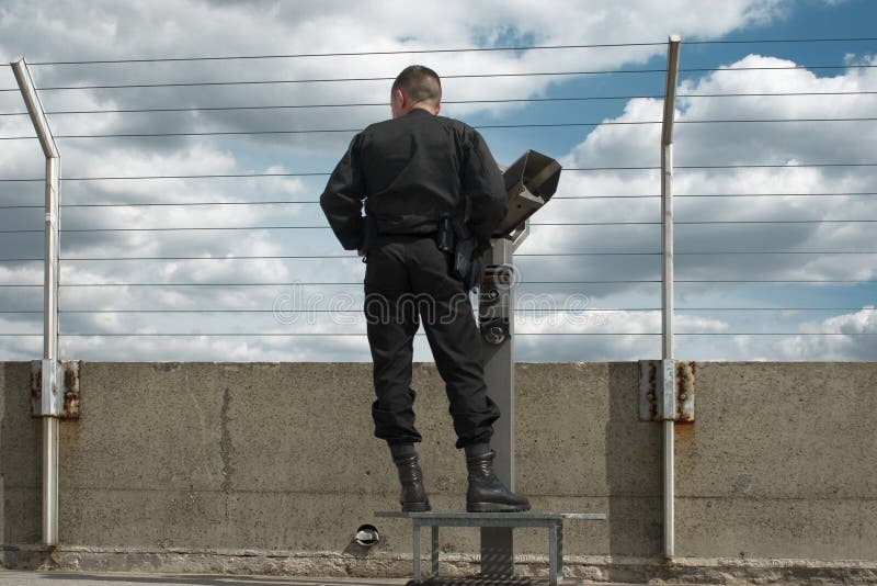 Gard. Gard watching through a fence royalty free stock image