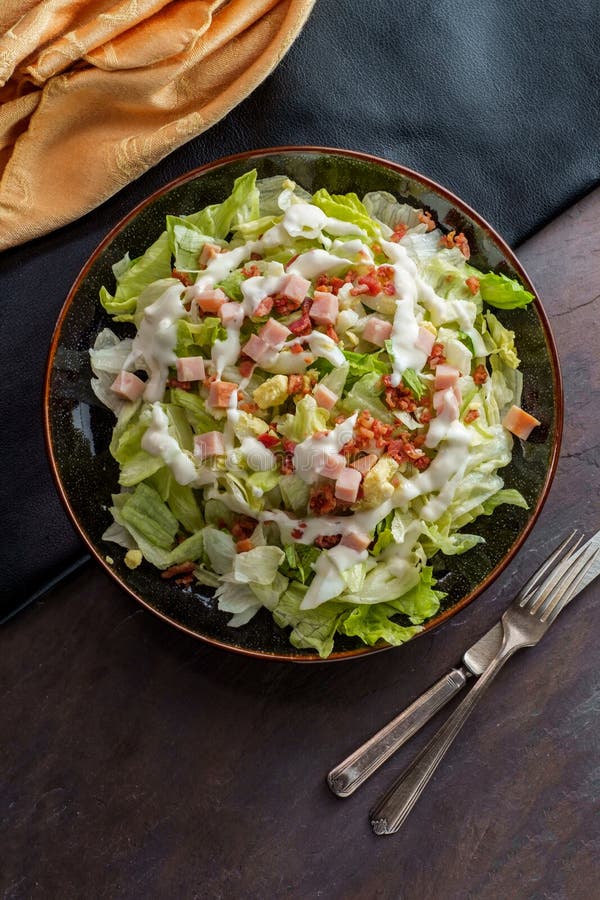 Garden cobb salad with iceberg lettuce ham bacon and hardboiled eggs