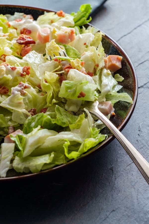 Garden cobb salad with iceberg lettuce ham bacon and hardboiled eggs