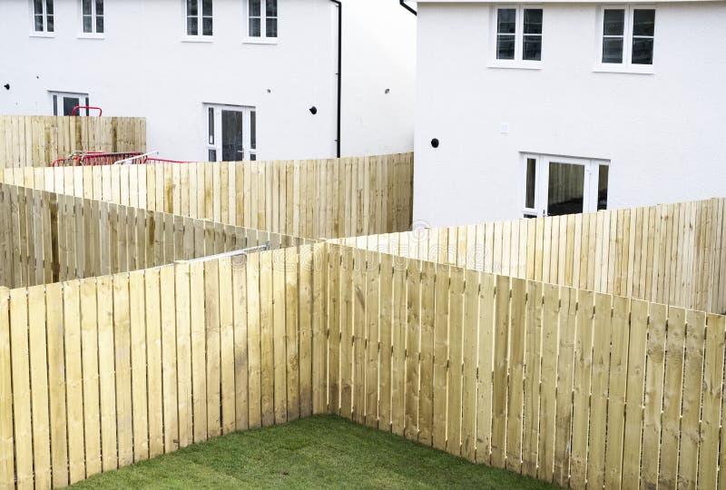 Garden fence made of wood planks across new build houses