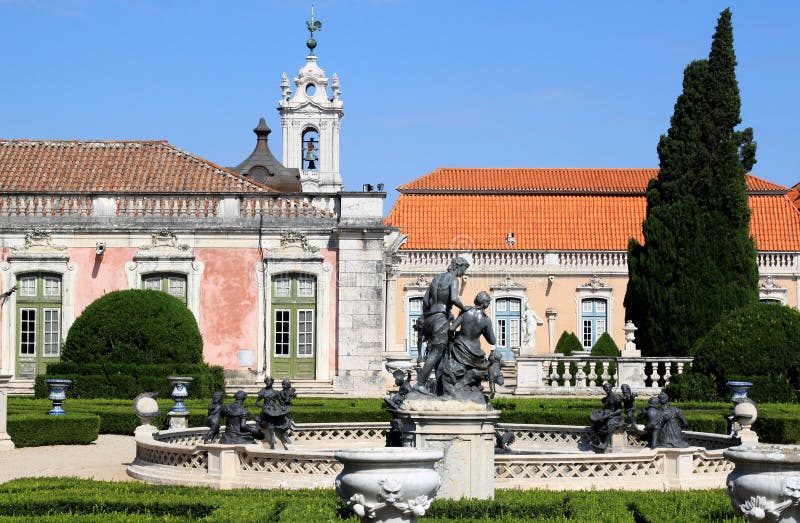 The Rococo Baroque style 18th-century Palacio Nacional de Queluz on the edge of Lisbon, built as a summer retreat for Dom Pedro of Braganza, who later became King after marrying his niece Maria I. In the front one of the fountains with bronze statues in the garden. At the background the tower of the Dona Maria. The Rococo Baroque style 18th-century Palacio Nacional de Queluz on the edge of Lisbon, built as a summer retreat for Dom Pedro of Braganza, who later became King after marrying his niece Maria I. In the front one of the fountains with bronze statues in the garden. At the background the tower of the Dona Maria.