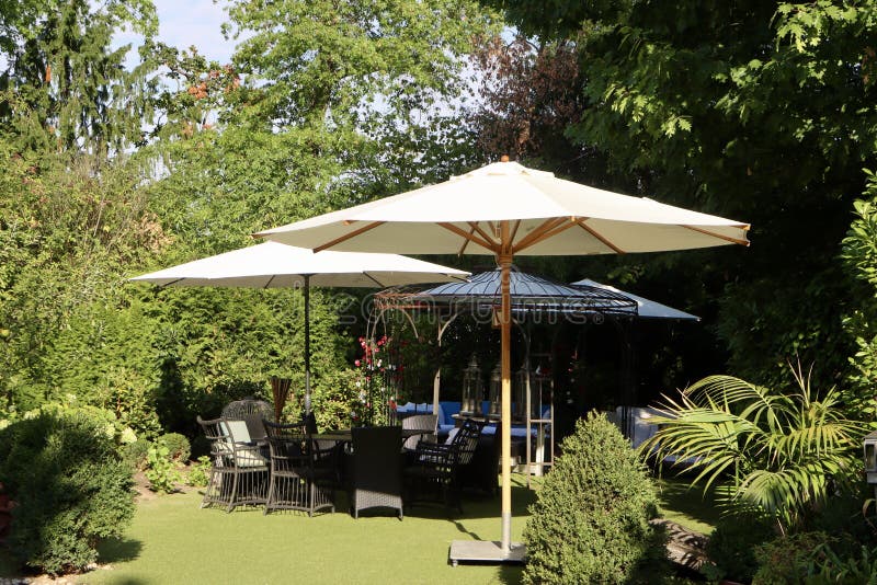 Garden with parasols stock image. Image of resort, green 259851031
