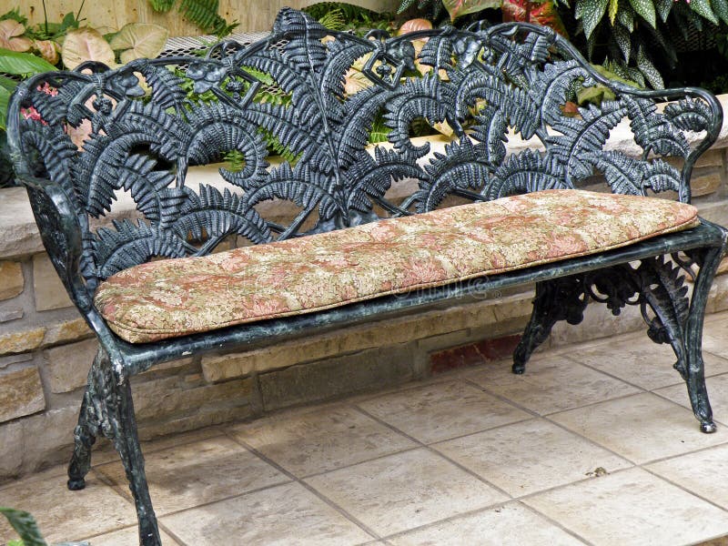 Wrought iron garden bench royalty free stock photo