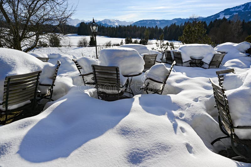 Table and chairs stuck in the snow on nice winter day in Alps. Table and chairs stuck in the snow on nice winter day in Alps.