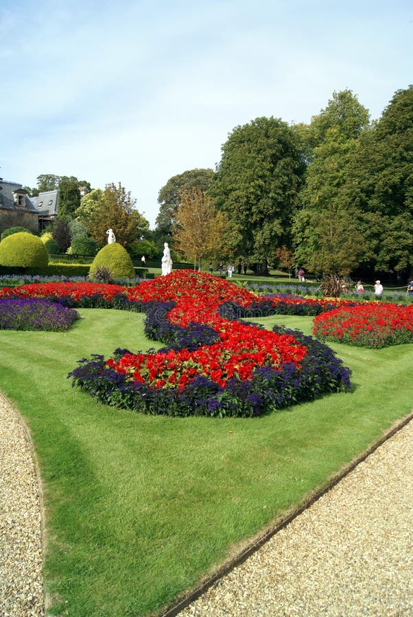 Garden with topiary trees, flower beds, and statues