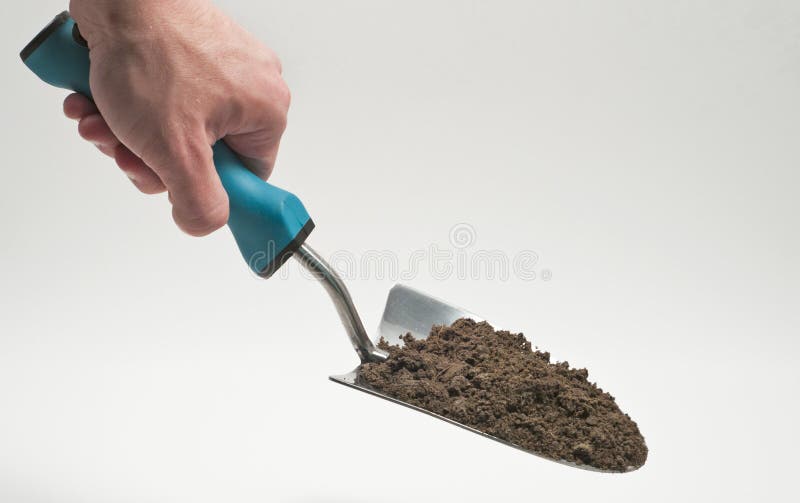 Garden trowel held with dirt