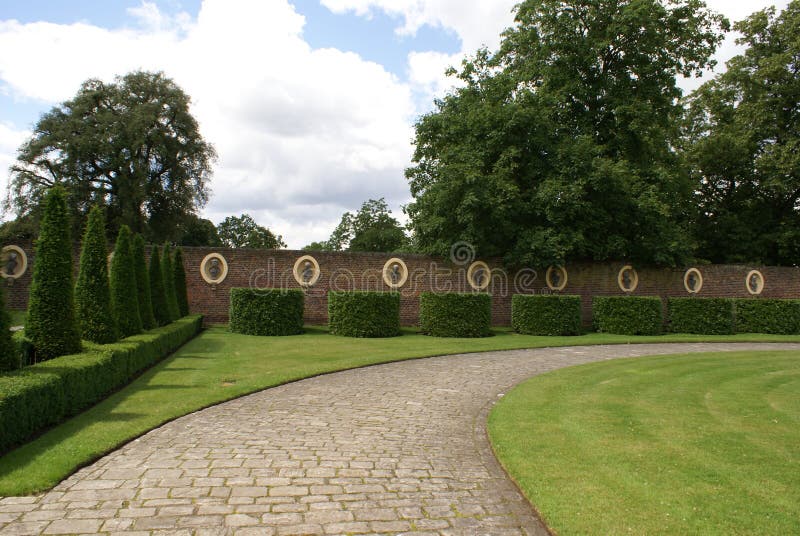 Garden wall, statues, topiary, and pathway