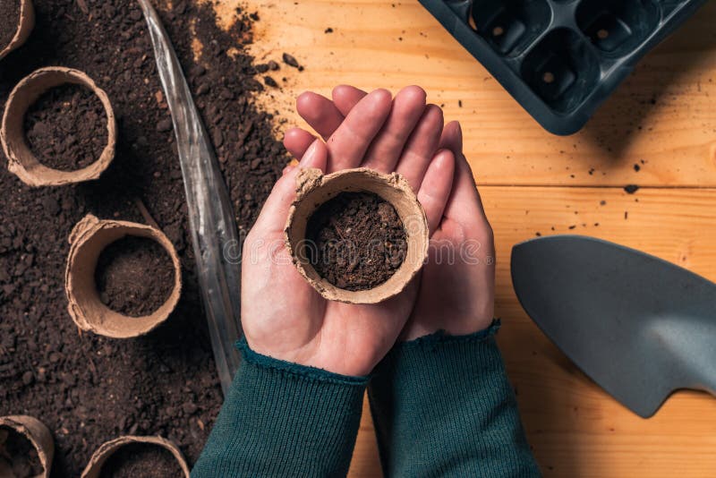 Gardener with biodegradable soil pot container royalty free stock photo Gardener with biodegradable soil pot container royalty free stock photo