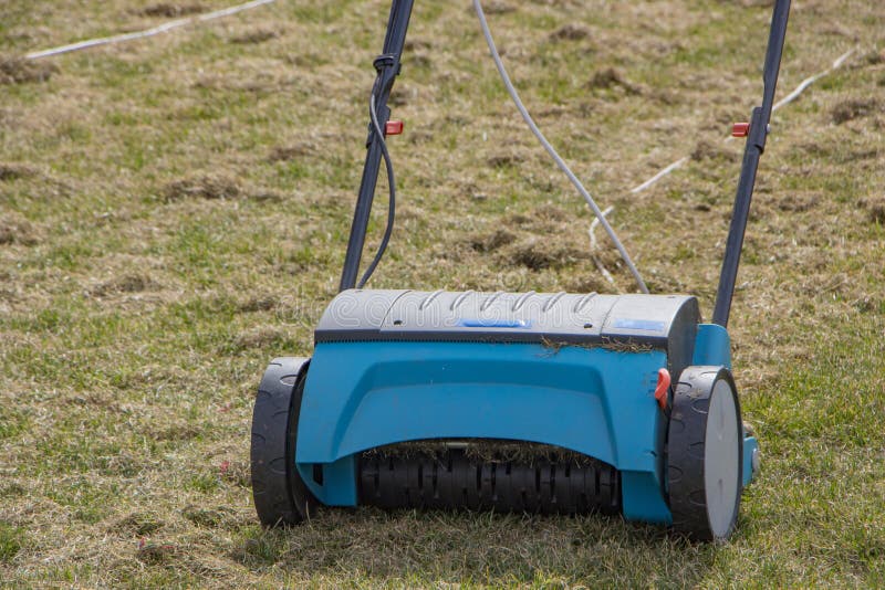 Gardener Operating Soil Aeration Machine on Grass Lawn Stock Image