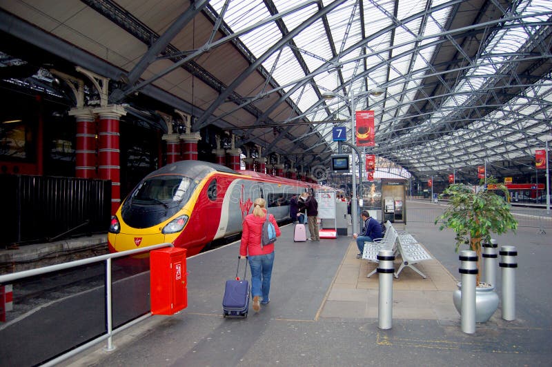 Image of the interior of London's Railway Station terminal with Virgin high Speed train on tracks. Image of the interior of London's Railway Station terminal with Virgin high Speed train on tracks.