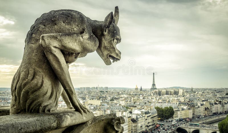 Gargoyle on the Cathedral of Notre Dame de Paris looks at the Eiffel Tower, Paris, France