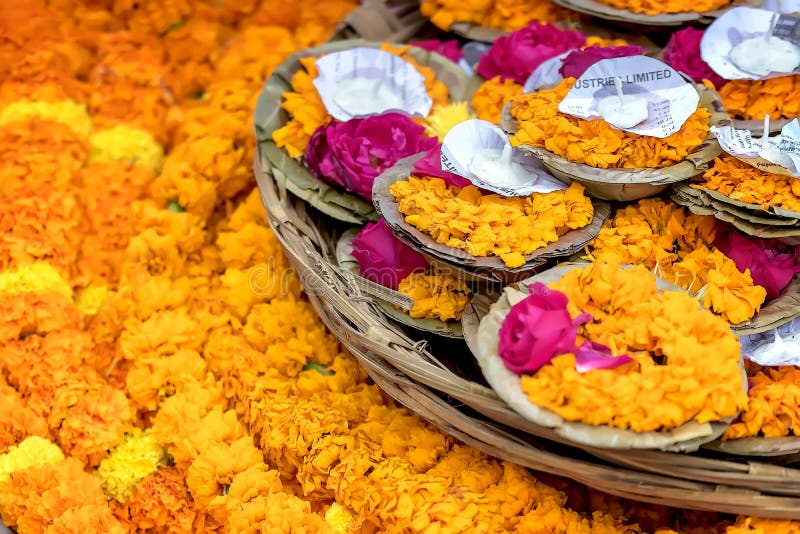 Floating garlands of flowers and floating candles placed by pilgrims on the river Ganges as offerings.