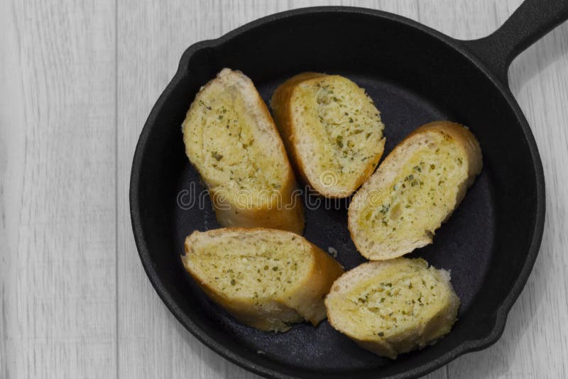 Garlic Bread with Herbs in a Cast Iron Frying Pan. Stock Photo Image