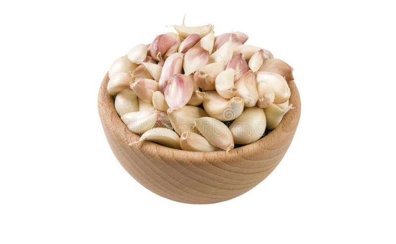 Garlic cloves in wooden bowl isolated on white background. 45 degree view. Spices and food ingredients