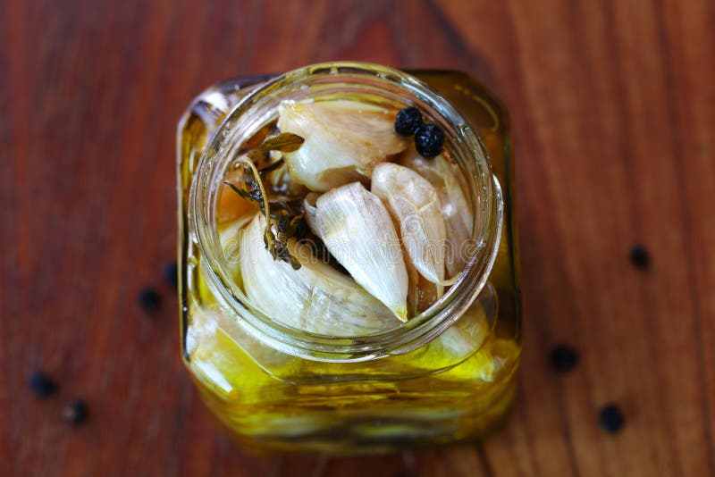 Garlic Confit Preserved in Olive Oil with Herbs an Stock Image Image