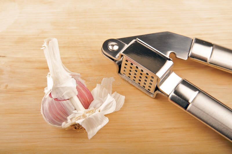 Garlic and garlic press stock image. Image of cooking 9133569