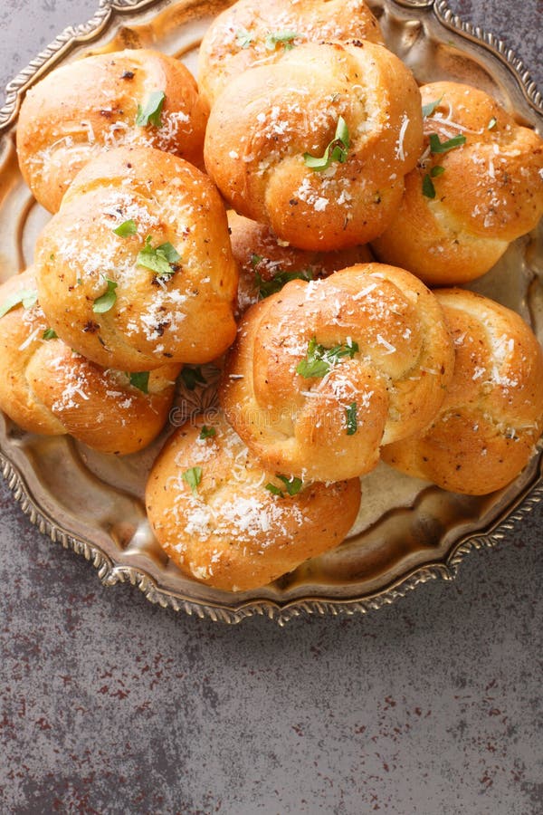 Garlic Herb and Cheese Rolls or Knots Bread Closeup on the Plate on the