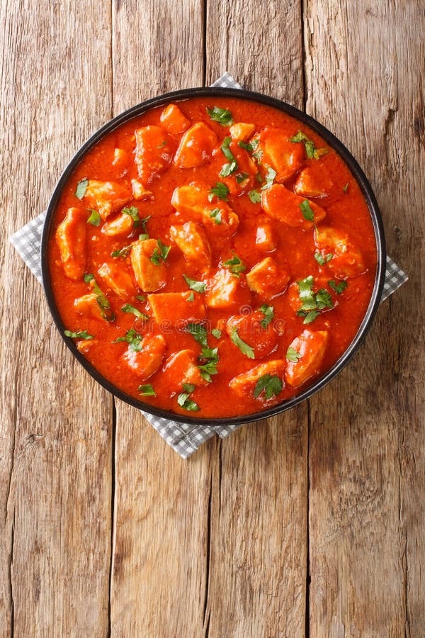 Garlic and Tomato Sauce Chicken Ostropel Closeup in the Plate. Vertical