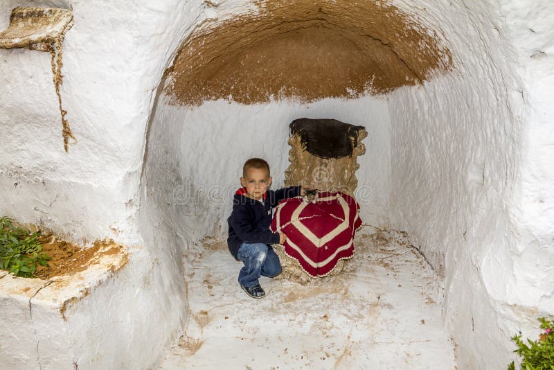 Matmata.Tunisia.May 21, 2013.Boy in the Underground home of troglodytes indigenous peoples inhabiting the Sahara desert in Tunisia. Matmata.Tunisia.May 21, 2013.Boy in the Underground home of troglodytes indigenous peoples inhabiting the Sahara desert in Tunisia