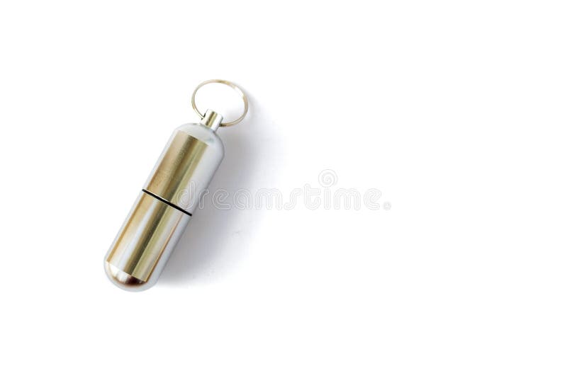 Closed aluminium pill bottle with a key ring, isolated on white background. Key chain bottle for storing medicine and other small items while hiking or going into expeditions - space for text. Closed aluminium pill bottle with a key ring, isolated on white background. Key chain bottle for storing medicine and other small items while hiking or going into expeditions - space for text