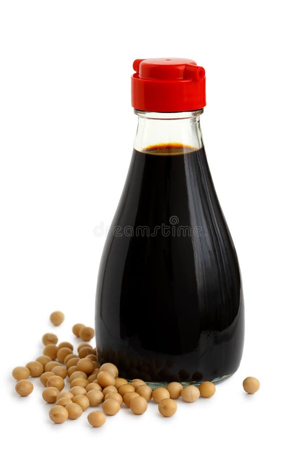 Glass bottle of soya sauce with red plastic lid isolated on white. Spilled soya beans. Glass bottle of soya sauce with red plastic lid isolated on white. Spilled soya beans.