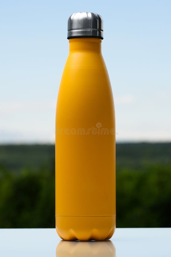 Garrafa inoxidável Thermo para a água, o chá ou o café Céu e floresta no fundo Na mesa de vidro Garrafa térmica da cor amarela ma imagens de stock Garrafa inoxidável Thermo para a água, o chá ou o café Céu e floresta no fundo Na mesa de vidro Garrafa térmica da cor amarela ma imagens de stock