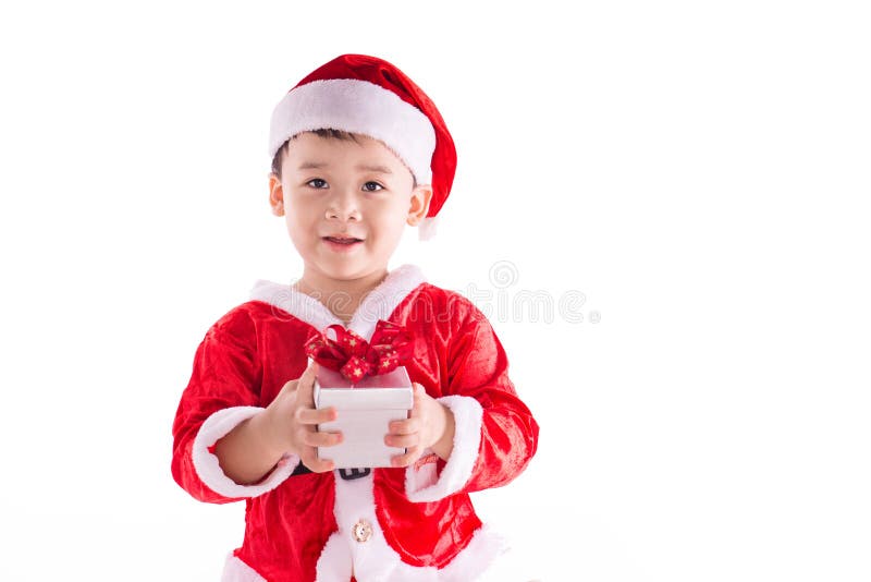 Garçon d'enfant de Noël en Santa Hat et cadeau image stock Garçon d'enfant de Noël en Santa Hat et cadeau image stock