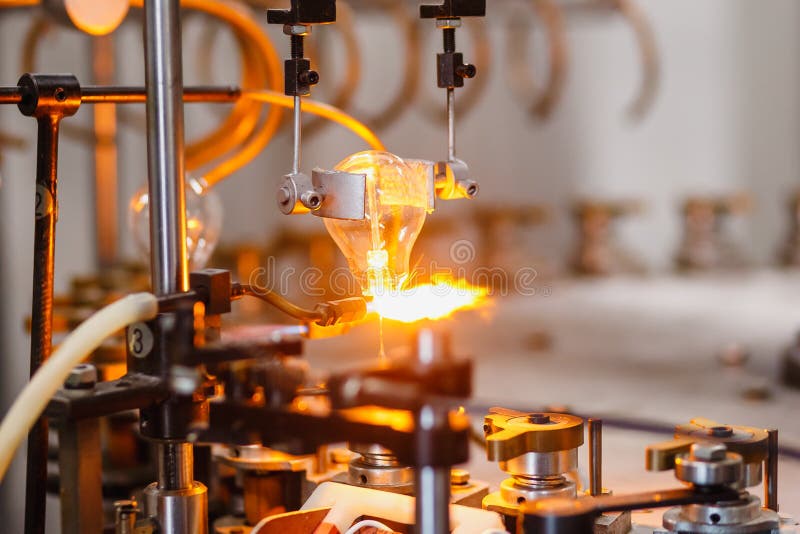 Gas burner conveyor for assembly and manufacture of electric glass lamps, soldering docking of luminous element stock photo