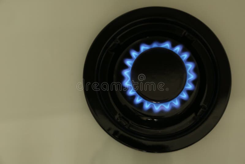 Gas Burner of Modern Stove with Burning Blue Flame, Top View Stock