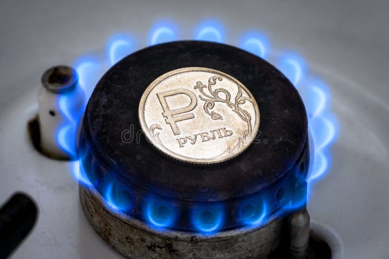 Gas burner and ruble coin, Russian money on home gas stove