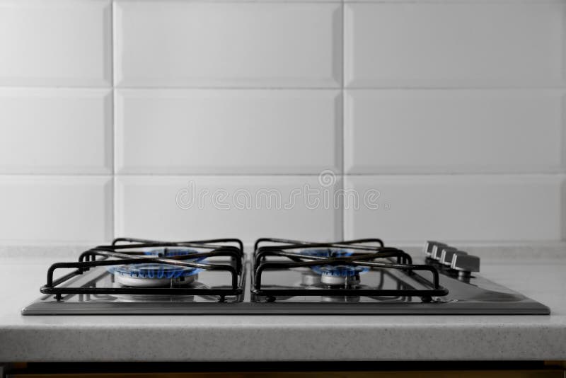 Gas Cooktop with Burning Blue Flames in Kitchen Stock Photo Image of