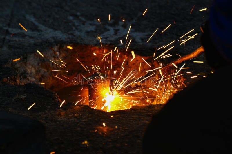 A gas cutter in production, a welder removes unnecessary metal residues with a gas cutter, sparks fly in different directions. stock photos A gas cutter in production, a welder removes unnecessary metal residues with a gas cutter, sparks fly in different directions. stock photos