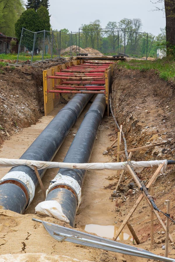 Gas Pipeline Under Construction. Black Pipes Buried in the Ground Stock