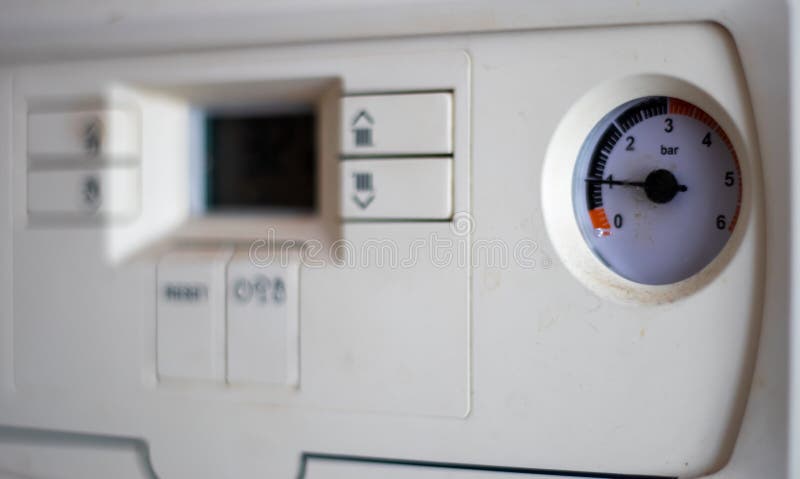 Gas pressure meter on the panel of the heating gas boiler. Symbolic image of the heating season at home. Dial and