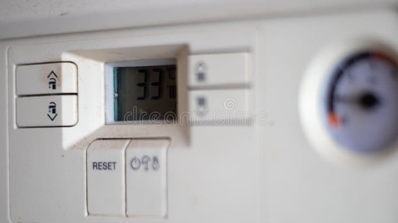 Gas pressure meter on the panel of the heating gas boiler. Symbolic image of the heating season at home. Dial and