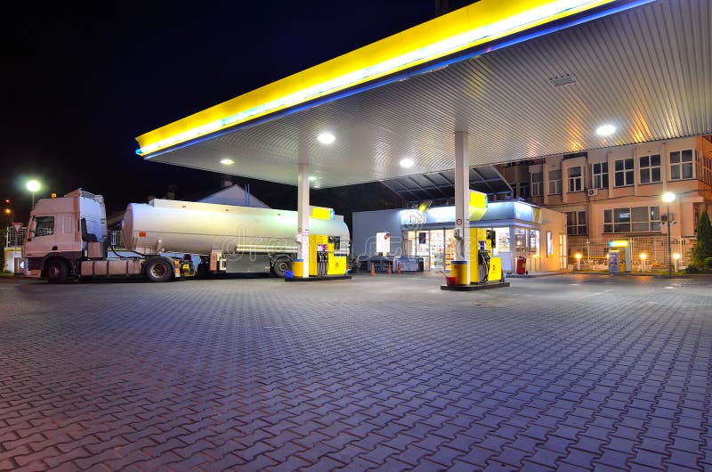 Truck with gasoline tank parked at the gas station at night waiting for unload the gasoline. Truck with gasoline tank parked at the gas station at night waiting for unload the gasoline.