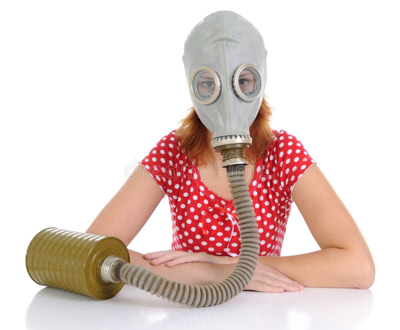 The woman with gas mask on a white background. Looking at camera. The woman with gas mask on a white background. Looking at camera