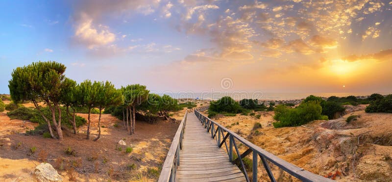 The gateway to La Barrosa beach at sunset in Cadiz, Spain