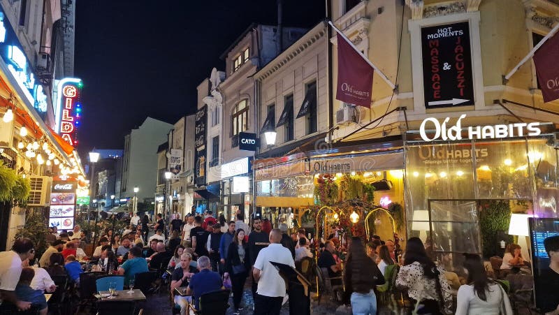 October, 14, 2023. Tourists and locals enjoy the nightlife in the old town of Bucharest, Romania. Street view, with old buildings, people, street cafes and restaurants. October, 14, 2023. Tourists and locals enjoy the nightlife in the old town of Bucharest, Romania. Street view, with old buildings, people, street cafes and restaurants.