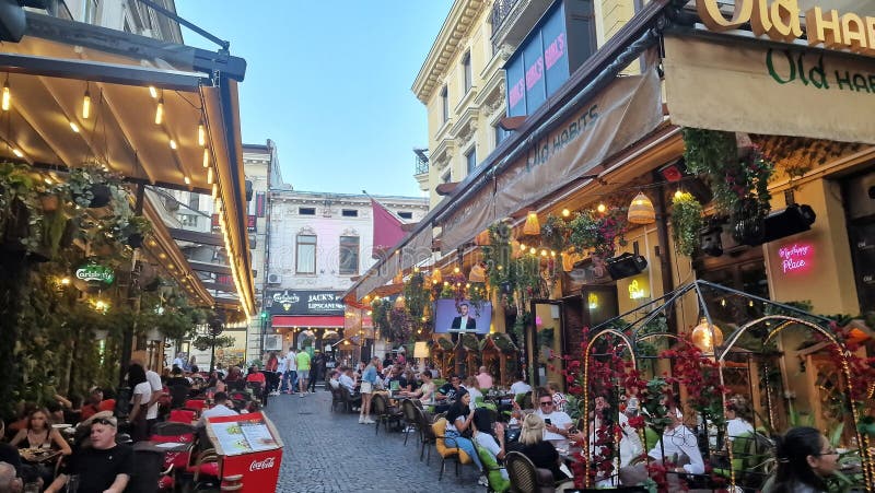 October, 14, 2023. Tourists and locals enjoy the nightlife in the old town of Bucharest, Romania. Street view, with old buildings, people, street cafes and restaurants. October, 14, 2023. Tourists and locals enjoy the nightlife in the old town of Bucharest, Romania. Street view, with old buildings, people, street cafes and restaurants.