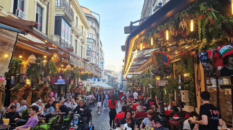 October, 14, 2023. Tourists and locals enjoy the nightlife in the old town of Bucharest, Romania. Street view, with old buildings, people, street cafes and restaurants. October, 14, 2023. Tourists and locals enjoy the nightlife in the old town of Bucharest, Romania. Street view, with old buildings, people, street cafes and restaurants.