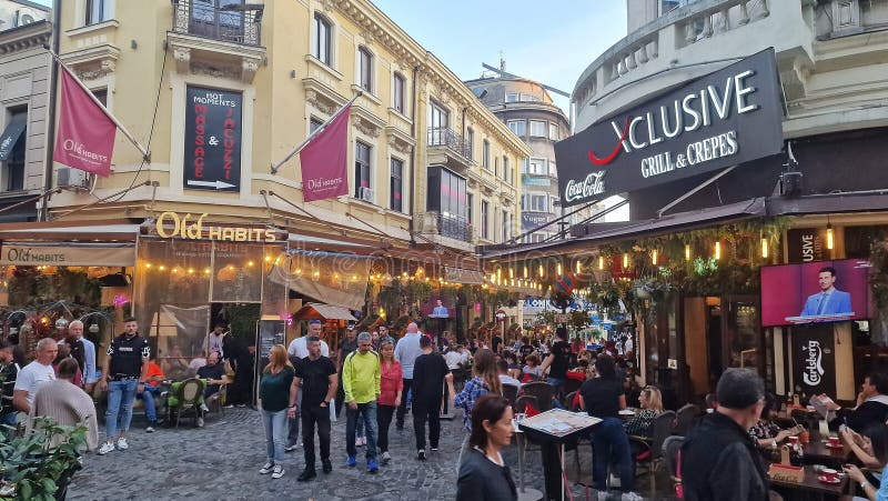 October, 14, 2023. Tourists and locals enjoy the nightlife in the old town of Bucharest, Romania. Street view, with old buildings, people, street cafes and restaurants. October, 14, 2023. Tourists and locals enjoy the nightlife in the old town of Bucharest, Romania. Street view, with old buildings, people, street cafes and restaurants.