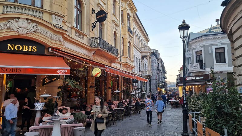 October, 14, 2023. Tourists and locals enjoy the nightlife in the old town of Bucharest, Romania. Street view, with old buildings, people, street cafes and restaurants. October, 14, 2023. Tourists and locals enjoy the nightlife in the old town of Bucharest, Romania. Street view, with old buildings, people, street cafes and restaurants.