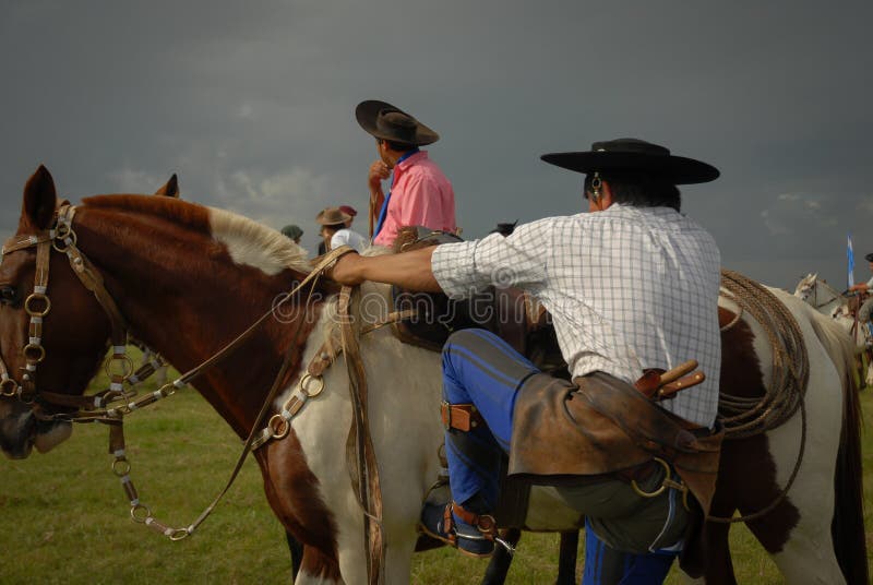 2 Gauchos in Their Argentine Clothes and Poncho Sitting Eating Barbecue ...