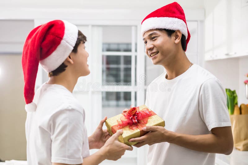 Gay Asian couple exchange christmas gift